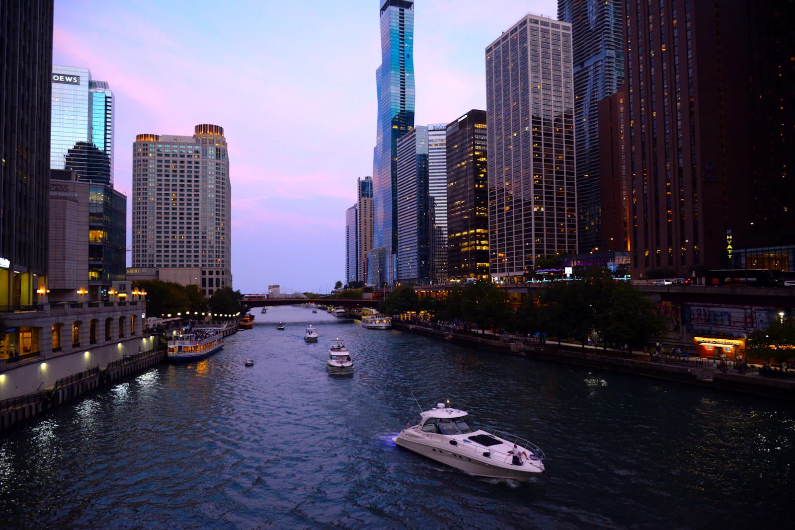 Boats on the Chicago River between downtown buildings